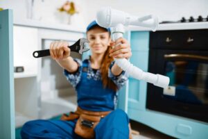 female plumber fixing pipes